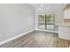 Bright dining room with hardwood floors, a large window, and a view of the pool at 389 Waterford W Cir, Tarpon Springs, FL 34688