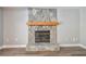 Close-up of the stone fireplace with a wood mantle and stone hearth at 389 Waterford W Cir, Tarpon Springs, FL 34688