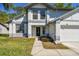 Close-up of a charming two-story home's entrance and landscaped front yard at 389 Waterford W Cir, Tarpon Springs, FL 34688