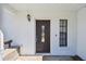 Close-up of the front door with decorative glass and a side window providing natural light at 389 Waterford W Cir, Tarpon Springs, FL 34688