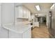 Modern kitchen boasts stainless steel appliances, white cabinets, and granite countertops at 389 Waterford W Cir, Tarpon Springs, FL 34688