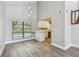 Open kitchen and dining area with hardwood floors, a pool view, and white cabinets at 389 Waterford W Cir, Tarpon Springs, FL 34688