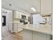 Bright kitchen featuring stainless steel appliances, a large countertop, and white cabinets at 389 Waterford W Cir, Tarpon Springs, FL 34688