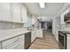 Beautiful kitchen with stainless steel appliances, white cabinets, and granite countertops at 389 Waterford W Cir, Tarpon Springs, FL 34688