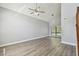 Spacious living room featuring vaulted ceilings, a ceiling fan, and hardwood floors at 389 Waterford W Cir, Tarpon Springs, FL 34688