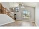 Bright living room with vaulted ceilings, wood floors, staircase, and large window at 389 Waterford W Cir, Tarpon Springs, FL 34688