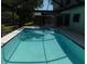 Screened-in pool with surrounding patio area for entertaining guests at 389 Waterford W Cir, Tarpon Springs, FL 34688