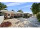 This backyard has a brick patio, grill, seating, and a screened in lanai at 3918 Versailles Dr, Tampa, FL 33634