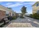 Beautiful brick home featuring a large, paved backyard with a screened-in patio and serene outdoor seating area at 3918 Versailles Dr, Tampa, FL 33634