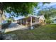 Landscaped backyard featuring brick paved patio and adjacent screened in lanai, perfect for outdoor living at 3918 Versailles Dr, Tampa, FL 33634