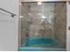 Full bathroom with glass shower doors, earth tone tile, and modern fixtures at 3918 Versailles Dr, Tampa, FL 33634