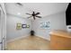 This cozy bedroom features neutral carpet, a ceiling fan, and a bright window at 3918 Versailles Dr, Tampa, FL 33634