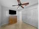 This bedroom boasts a ceiling fan, closet, and a mounted TV at 3918 Versailles Dr, Tampa, FL 33634