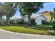 Single-story home featuring a two-car garage, a well-maintained lawn, and a classic brick-accented facade at 3918 Versailles Dr, Tampa, FL 33634