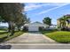 Traditional single-story home featuring a two-car garage, well-manicured lawn, and a classic brick-accented facade at 3918 Versailles Dr, Tampa, FL 33634