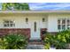 Charming front entrance with decorative brick accents, beautiful plants, and a well lit doorway at 3918 Versailles Dr, Tampa, FL 33634