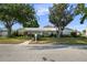 Charming single-story home featuring a well-maintained lawn, mature trees, and a welcoming walkway at 3918 Versailles Dr, Tampa, FL 33634