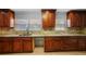 Well-lit kitchen with stone countertops and backsplash with dark wood cabinetry at 3918 Versailles Dr, Tampa, FL 33634