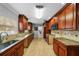Spacious kitchen with granite countertops, stone backsplash, and wood cabinetry at 3918 Versailles Dr, Tampa, FL 33634