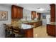 Elegant kitchen features custom cabinets, granite counters, tile backsplash, and bar stool seating at 3918 Versailles Dr, Tampa, FL 33634