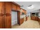 Open concept kitchen with granite countertops and dark wood cabinetry at 3918 Versailles Dr, Tampa, FL 33634
