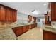 Spacious eat-in kitchen with granite countertops, stone backsplash, and tile floors at 3918 Versailles Dr, Tampa, FL 33634