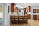 Gourmet kitchen features custom cabinets, granite counters, and bar stool seating at 3918 Versailles Dr, Tampa, FL 33634