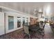 This lanai features a table and chairs, fans, and brick accents at 3918 Versailles Dr, Tampa, FL 33634