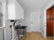 Clean and efficient laundry room featuring a stainless steel sink, ample cabinetry, and direct access to the outdoors at 3918 Versailles Dr, Tampa, FL 33634