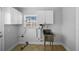 Functional laundry room with utility sink, cabinets, and convenient access for household chores and cleaning at 3918 Versailles Dr, Tampa, FL 33634