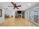 Cozy living room with a stone fireplace and double doors leading to an outdoor area at 3918 Versailles Dr, Tampa, FL 33634