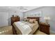 Comfortable bedroom featuring a queen sized bed, ceiling fan, shuttered windows and two dressers at 3918 Versailles Dr, Tampa, FL 33634