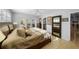 Bright bedroom featuring a comfortable bed, ceiling fan, access to the outside and a partial view of the bathroom at 3918 Versailles Dr, Tampa, FL 33634
