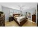 Spacious main bedroom with ceiling fan, shuttered windows, and access to the outdoors through glass doors at 3918 Versailles Dr, Tampa, FL 33634