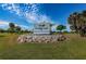 Community sign for Rocky Point, set amidst a landscaped area with palm trees at 3918 Versailles Dr, Tampa, FL 33634