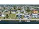 Aerial view of home with a dock on the water in a community with other waterfront properties at 4290 Carlos Ct, Hernando Beach, FL 34607