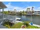 Waterfront backyard features a well maintained lawn and dock with a view of neighboring houses at 4290 Carlos Ct, Hernando Beach, FL 34607