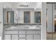Bathroom with granite countertops, updated lighting, and double mirrors reflecting the shower at 4290 Carlos Ct, Hernando Beach, FL 34607