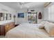 Comfortable bedroom with coastal decor, slider to balcony, and a large dresser at 4290 Carlos Ct, Hernando Beach, FL 34607