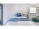 Cozy bedroom features white walls and bedding, a cool blue accent blanket, and natural light at 4290 Carlos Ct, Hernando Beach, FL 34607