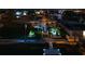 Nighttime view of a waterfront home featuring a private dock, elevated deck, and landscape lighting at 4290 Carlos Ct, Hernando Beach, FL 34607