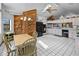 Open-concept kitchen featuring a dining table, black appliances and plenty of countertop space at 4290 Carlos Ct, Hernando Beach, FL 34607