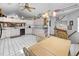Bright and open kitchen featuring a dining table, updated appliances and a clean white tile floor at 4290 Carlos Ct, Hernando Beach, FL 34607