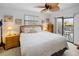 Comfortable main bedroom featuring a private balcony, ceiling fan and an abundance of natural light at 4290 Carlos Ct, Hernando Beach, FL 34607
