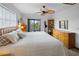 Comfortable main bedroom featuring a private balcony, ceiling fan and an abundance of natural light at 4290 Carlos Ct, Hernando Beach, FL 34607