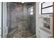 Modern tiled shower with built-in seating, glass door and grab bar for added safety at 4290 Carlos Ct, Hernando Beach, FL 34607