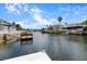 Picturesque waterfront view from a dock, featuring a calm canal and neighboring homes at 4290 Carlos Ct, Hernando Beach, FL 34607