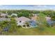 An aerial view of the home featuring a pool, screened-in lanai, and lush landscaping at 4608 Kilcoyne Ct, Lutz, FL 33558