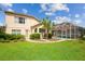 A beautiful backyard with a screened in pool and an inviting lawn for entertaining or Gathering fun at 4608 Kilcoyne Ct, Lutz, FL 33558