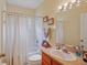 Bright bathroom features a shower and tub combination with a single sink vanity and decorative mirror at 4608 Kilcoyne Ct, Lutz, FL 33558
